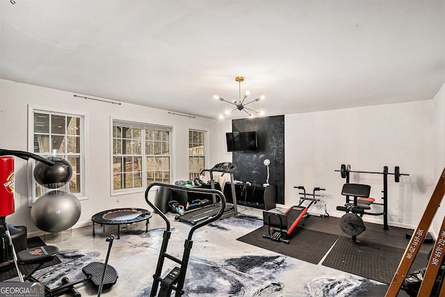 workout area featuring a chandelier