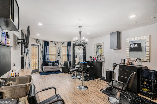 office space featuring light hardwood / wood-style flooring and an inviting chandelier