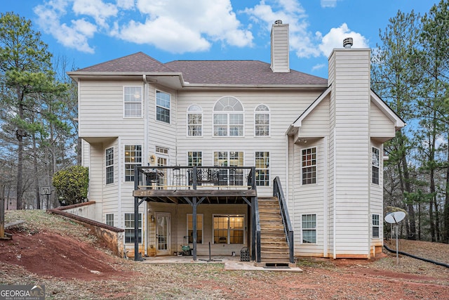 rear view of house with a deck and a patio