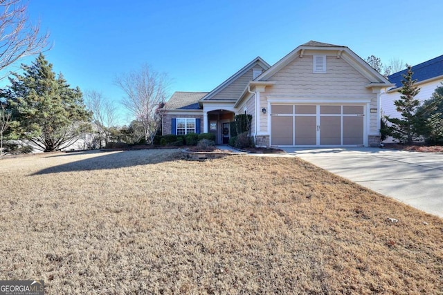 view of front of property with a garage and a front lawn