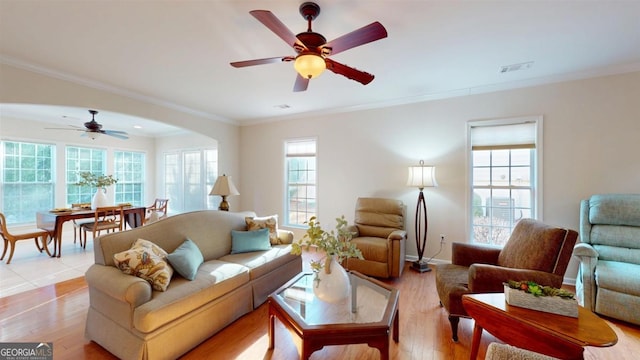 living room with light hardwood / wood-style floors and ornamental molding