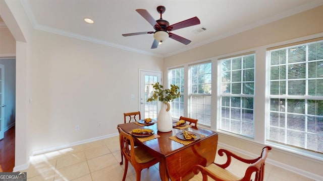 tiled dining room featuring ceiling fan and ornamental molding