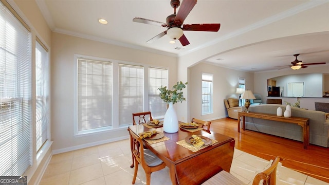 dining area featuring light tile patterned flooring, ceiling fan, and ornamental molding