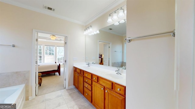 bathroom featuring tile patterned floors, a tub, vanity, and crown molding