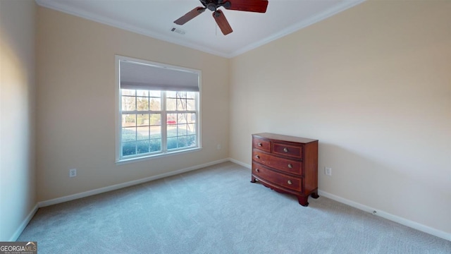 empty room with ornamental molding, light carpet, and ceiling fan