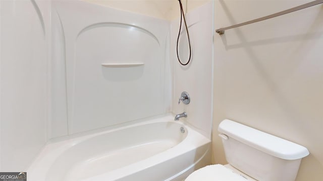 bathroom featuring bathtub / shower combination and toilet