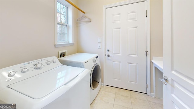 washroom featuring light tile patterned floors and separate washer and dryer