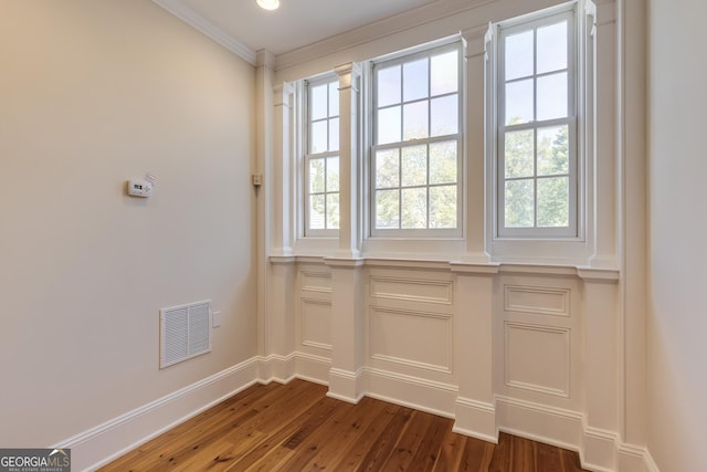 interior details featuring crown molding and wood-type flooring