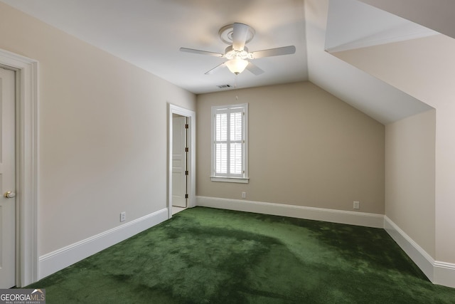 additional living space featuring ceiling fan, dark colored carpet, and lofted ceiling