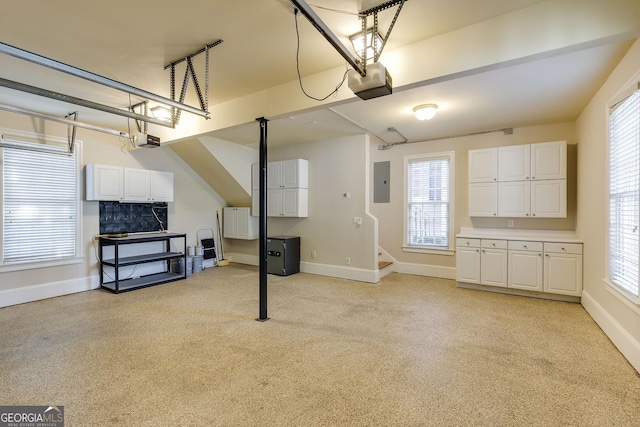 garage with electric panel and a garage door opener