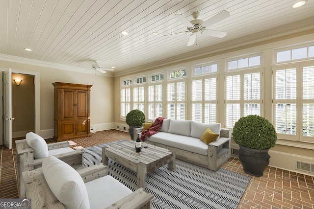 living room with ceiling fan, plenty of natural light, crown molding, and wooden ceiling