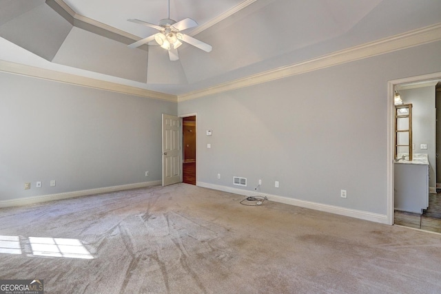 spare room with light carpet, baseboards, visible vents, and crown molding