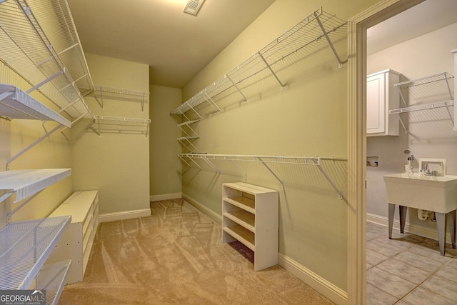 spacious closet with light carpet and visible vents