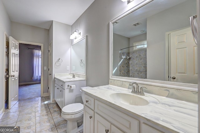 full bath featuring visible vents, toilet, a sink, tile patterned flooring, and two vanities