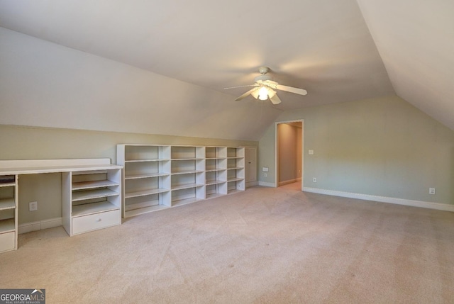 bonus room featuring a ceiling fan, lofted ceiling, light colored carpet, and baseboards