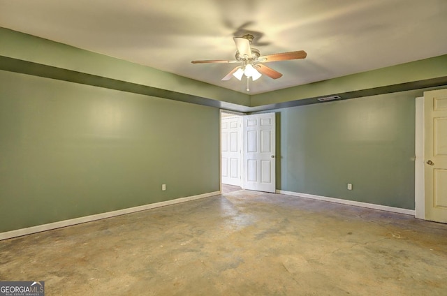 unfurnished bedroom with a ceiling fan, concrete floors, and baseboards