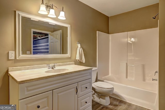 bathroom featuring vanity, shower / bath combination, wood finished floors, and toilet