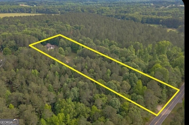 birds eye view of property featuring a wooded view