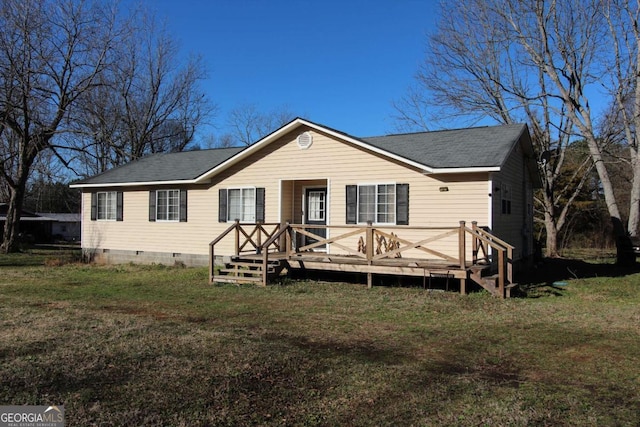 view of front of property with a deck and a front yard