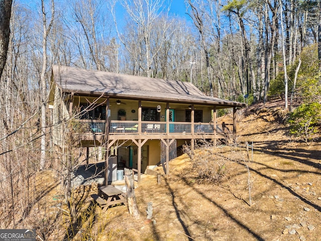 back of house with ceiling fan and a deck