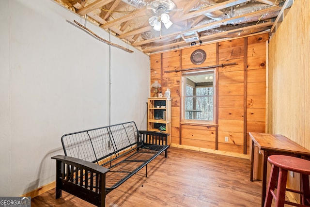 bedroom featuring wooden walls and wood finished floors