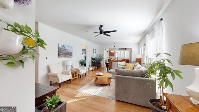 living room featuring light hardwood / wood-style floors and ceiling fan