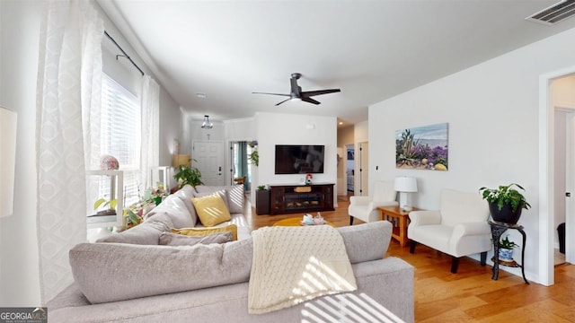 living room featuring ceiling fan and wood-type flooring