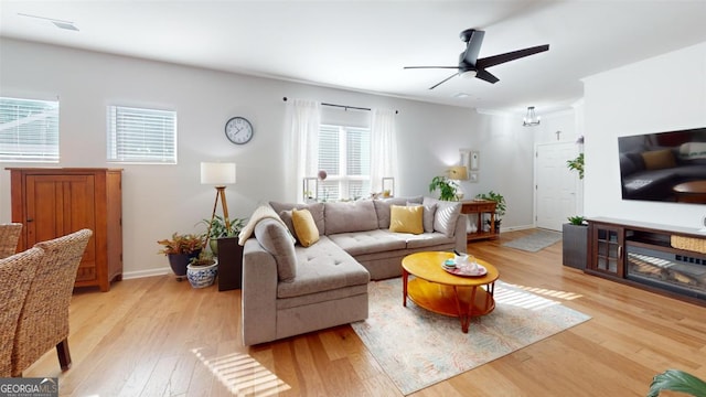 living room with ceiling fan and light wood-type flooring