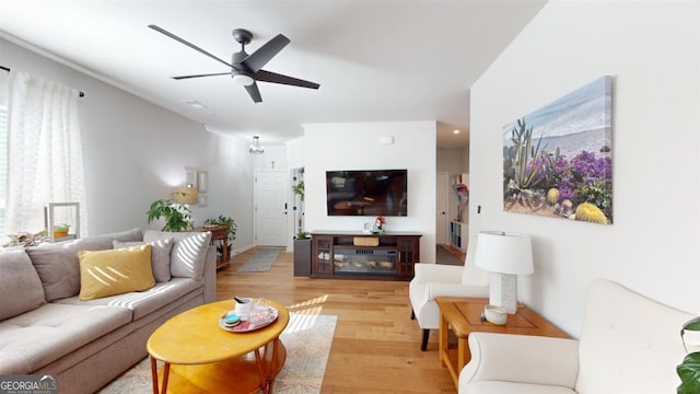 living room featuring light wood-type flooring and ceiling fan