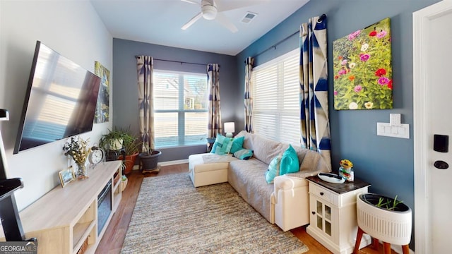 sitting room with hardwood / wood-style flooring and ceiling fan