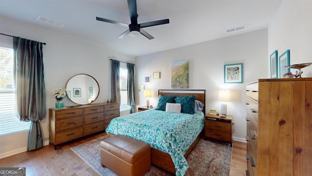 bedroom with ceiling fan and light hardwood / wood-style flooring