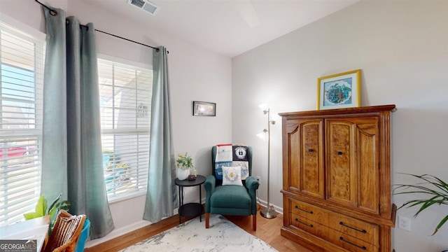 living area featuring light hardwood / wood-style floors and a healthy amount of sunlight