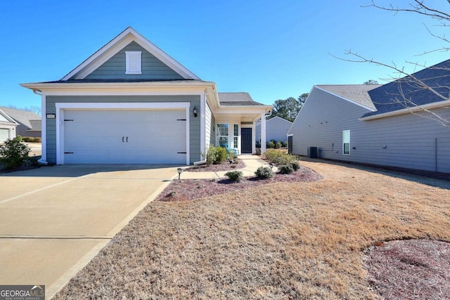 view of front of home featuring a garage and central air condition unit