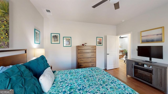 bedroom with hardwood / wood-style floors and ceiling fan