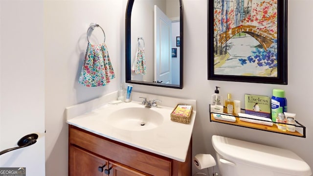 bathroom featuring toilet and vanity