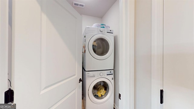 laundry room with stacked washer / drying machine