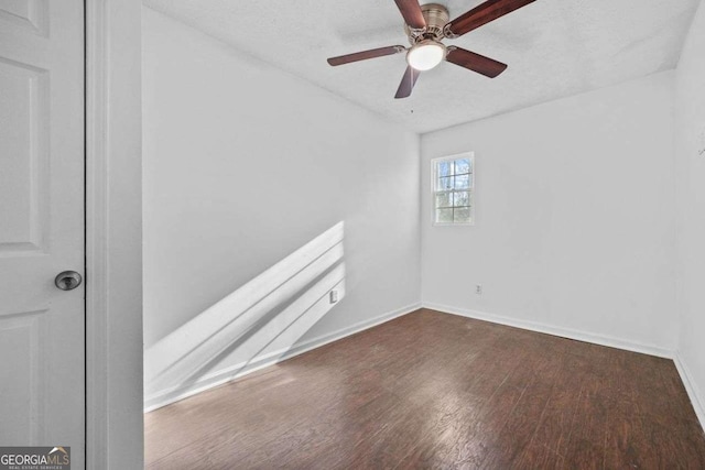 spare room with a textured ceiling, dark hardwood / wood-style floors, and ceiling fan