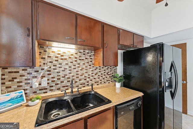 kitchen featuring sink, black appliances, light tile patterned flooring, and decorative backsplash