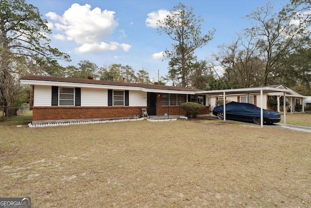 ranch-style home featuring a front lawn and a carport