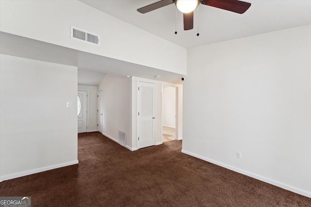 carpeted spare room featuring lofted ceiling and ceiling fan