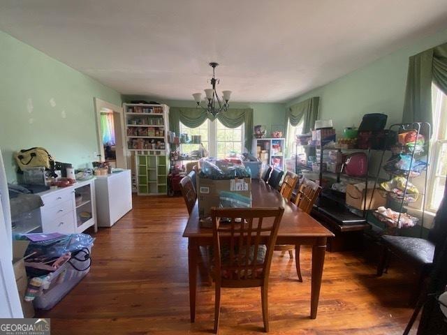 dining area featuring wine cooler, a chandelier, and wood-type flooring