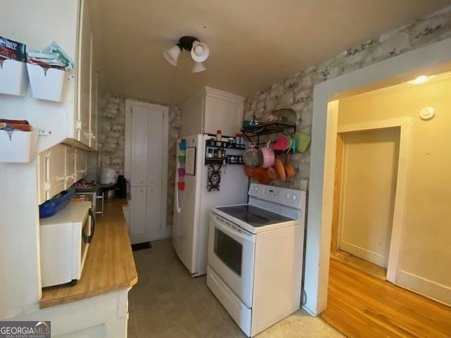 kitchen featuring white appliances and white cabinets