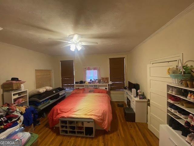 bedroom with hardwood / wood-style floors and ceiling fan