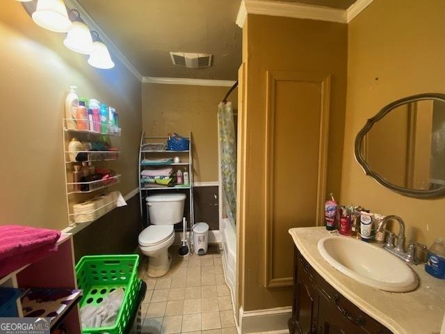 full bathroom with toilet, vanity, tile patterned flooring, and ornamental molding