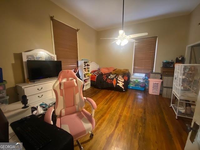 bedroom featuring hardwood / wood-style flooring and ceiling fan