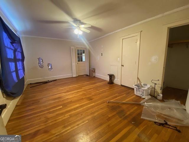 additional living space with hardwood / wood-style flooring and ceiling fan