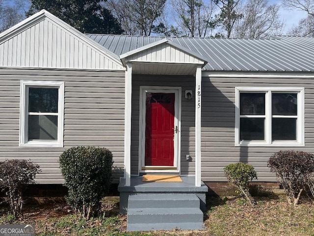 view of exterior entry featuring metal roof