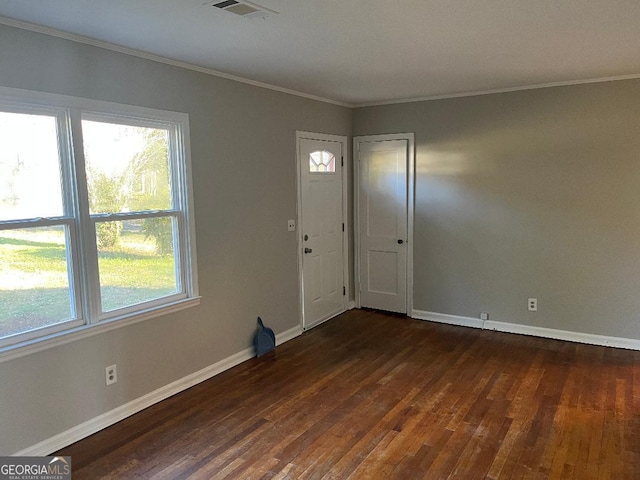 foyer entrance featuring crown molding, dark wood-type flooring, visible vents, and baseboards