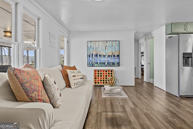 living room with hardwood / wood-style flooring and crown molding