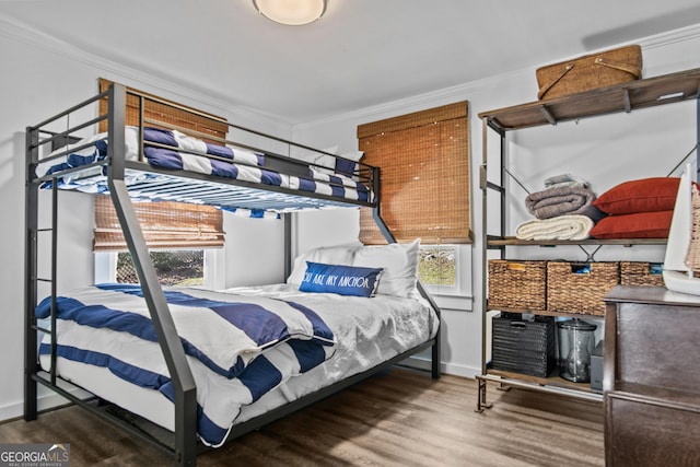 bedroom with wood-type flooring and crown molding